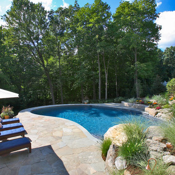 pool with Non-Scalable Stone Retaining Wall at end of Pool, serving as Town Code