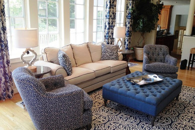 Example of a large beach style enclosed light wood floor family room design in DC Metro with white walls, a standard fireplace and a wood fireplace surround