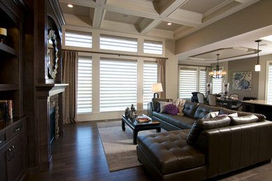 Large trendy open concept and formal dark wood floor and brown floor living room photo in Calgary with beige walls, a standard fireplace, a wood fireplace surround and no tv
