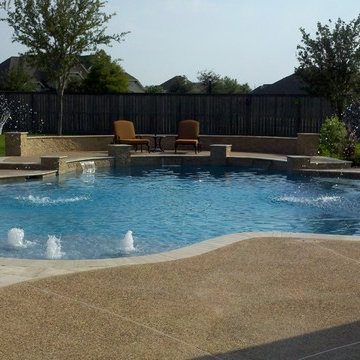Freeform Travertine Pool with Raised Decking & Oversized Spa