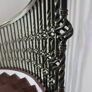 Walnut Circular Stair with Twist & Basket Iron Balusters