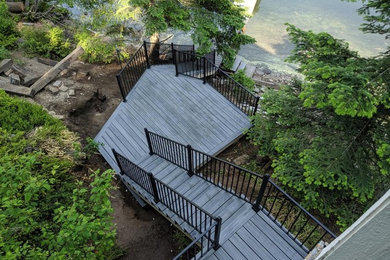 Example of a mid-sized classic backyard deck design in Seattle with no cover