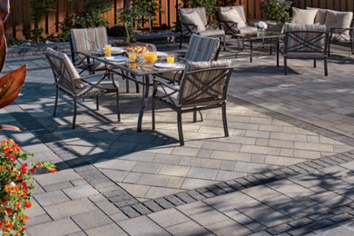 Inspiration for a mid-sized modern backyard brick patio remodel in Toronto