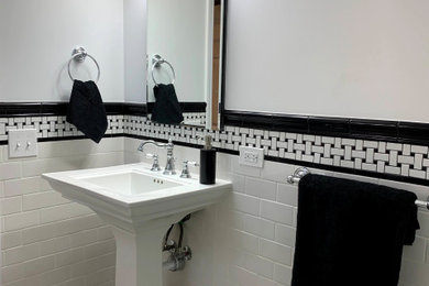 Inspiration for a mid-sized timeless 3/4 white tile and subway tile ceramic tile, white floor and single-sink alcove shower remodel in Chicago with white cabinets, a two-piece toilet, gray walls, a pedestal sink, a niche and a freestanding vanity