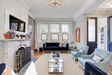 Inspiration for a victorian open concept light wood floor family room remodel in Seattle with gray walls, a standard fireplace and a wall-mounted tv