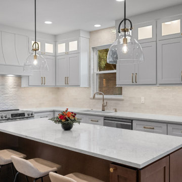 Modern Two-Tone Kitchen with white Cabinetry and Textured Backsplash