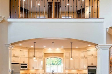 Eat-in kitchen - huge traditional u-shaped medium tone wood floor eat-in kitchen idea in Columbus with raised-panel cabinets, white cabinets, granite countertops, stainless steel appliances and an island