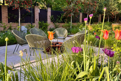 Photo of a large contemporary back patio in London.