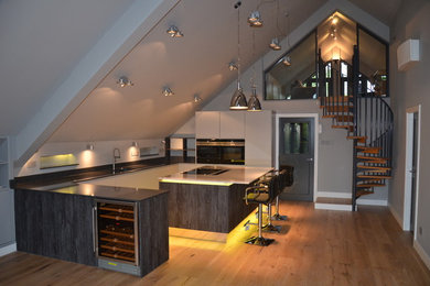 This is an example of a large modern u-shaped open plan kitchen in Other with quartz worktops and an island.