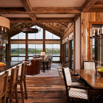 Hand Hewn Timbers and Weathered Antique Paneling in Open Farmhouse Living Space