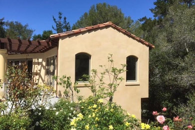 Inspiration for a mid-sized mediterranean beige one-story stucco gable roof remodel in San Francisco