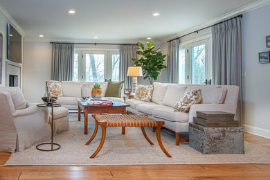 Example of a large transitional formal and enclosed medium tone wood floor and brown floor living room design in Other with gray walls, a standard fireplace, a concrete fireplace and a wall-mounted tv