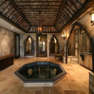 This is an example of a mediterranean fully buried basement in Atlanta with grey walls, no fireplace and travertine flooring.