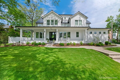 Large farmhouse white three-story concrete fiberboard exterior home idea in Chicago with a metal roof