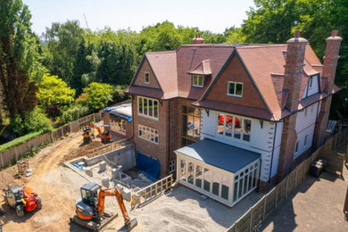 Design ideas for an expansive and multi-coloured modern rear detached house in West Midlands with four floors and a red roof.