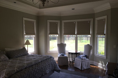 Photo of a mid-sized traditional master bedroom in Nashville with beige walls and light hardwood floors.