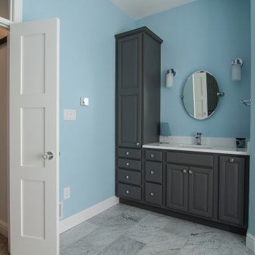 Traditional master bath utilizing frosted and clear glass to allow for needed pr