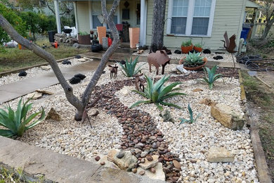 This is an example of a modern full sun front yard concrete paver landscaping in Austin.