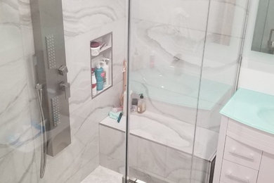 Example of a mid-sized minimalist 3/4 cement tile floor corner shower design in Los Angeles with glass countertops