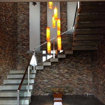 MODERN CHANDELIER IN TWO STORY STAIRCASE