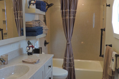 Bathroom - mid-sized transitional beige tile vinyl floor and brown floor bathroom idea in Other with furniture-like cabinets, beige cabinets, a two-piece toilet, white walls, an integrated sink, onyx countertops and beige countertops