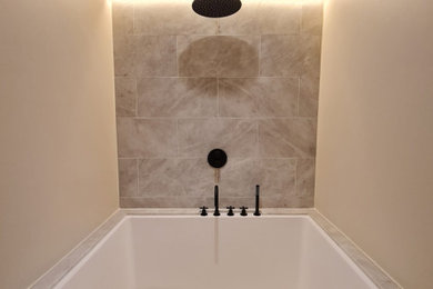 Bathtub finished with marble with top shower