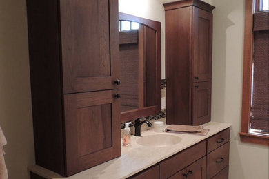 Drop-in bathtub - mid-sized transitional master beige tile and stone tile travertine floor and beige floor drop-in bathtub idea in Other with shaker cabinets, brown cabinets, white walls and quartz countertops