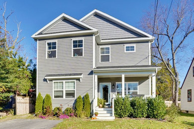 This is an example of a large traditional two-storey grey house exterior in Other with vinyl siding.
