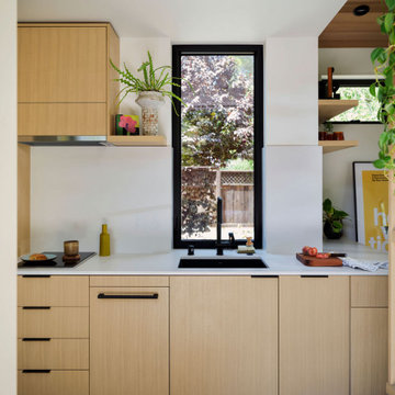 Contemporary ADU Sink Wall with Black Faucet and Custom Oak Cabinetry