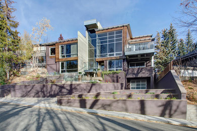 Example of a large minimalist two-story concrete fiberboard flat roof design in Calgary