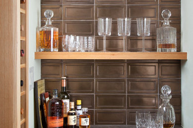 Inspiration for a small contemporary home bar in Austin with no sink, flat-panel cabinets, light wood cabinets, marble benchtops and light hardwood floors.