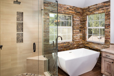 Inspiration for a mid-sized transitional master bathroom in Austin with raised-panel cabinets, distressed cabinets, a freestanding tub, a corner shower, beige tile, porcelain tile, dark hardwood floors, brown floor, a hinged shower door and beige benchtops.