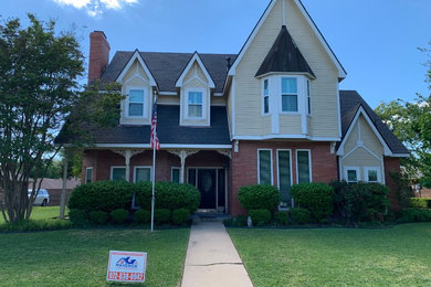 Inspiration for a mid-sized timeless beige two-story mixed siding exterior home remodel in Dallas with a shingle roof