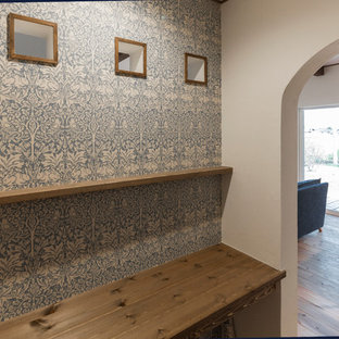 Photo of a modern study in Other with medium hardwood flooring and a built-in desk.
