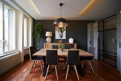 Design ideas for a contemporary dining room in Dijon with grey walls and orange floor.