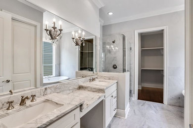 Inspiration for a contemporary bathroom remodel in New Orleans with marble countertops