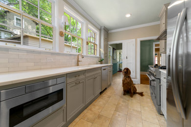 Example of a small transitional galley porcelain tile and beige floor enclosed kitchen design in Birmingham with a single-bowl sink, recessed-panel cabinets, gray cabinets, quartz countertops, white backsplash, ceramic backsplash, stainless steel appliances, no island and white countertops
