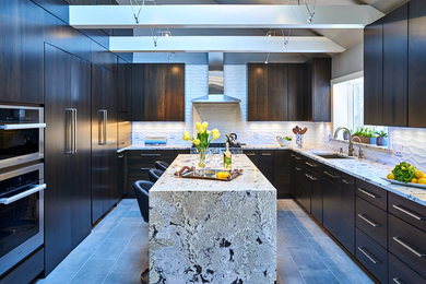 Inspiration for a large modern u-shaped porcelain tile, white floor and vaulted ceiling enclosed kitchen remodel in New York with an undermount sink, flat-panel cabinets, dark wood cabinets, granite countertops, white backsplash, porcelain backsplash, stainless steel appliances and an island