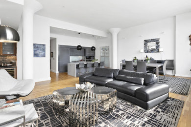 Living room - mid-sized contemporary open concept medium tone wood floor and brown floor living room idea with white walls and no fireplace