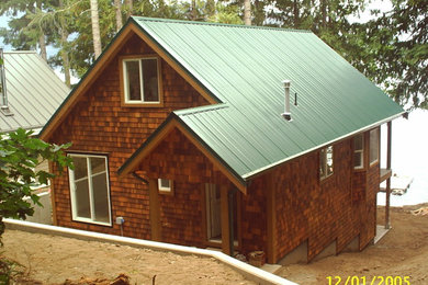 Inspiration for a mid-sized rustic brown three-story wood house exterior remodel in Vancouver