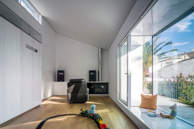 Large trendy gender-neutral medium tone wood floor kids' room photo in Other with white walls