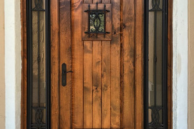 Design ideas for a mid-sized country front door in Miami with beige walls, a single front door and a dark wood front door.