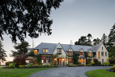 Huge elegant three-story stucco exterior home photo in Seattle