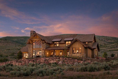 Country exterior in Phoenix with wood siding and a mixed roof.