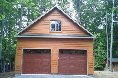 Mid-sized mountain style detached two-car garage photo in Montreal
