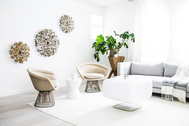 Inspiration for a mid-sized scandinavian open concept and formal light wood floor living room remodel in Los Angeles with white walls, no fireplace and no tv