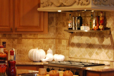 Open concept kitchen - large mediterranean open concept kitchen idea in San Francisco with a double-bowl sink, raised-panel cabinets, distressed cabinets, granite countertops, beige backsplash, stone tile backsplash, stainless steel appliances and two islands