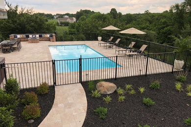 Large transitional backyard stone patio photo in Baltimore with a fire pit and no cover