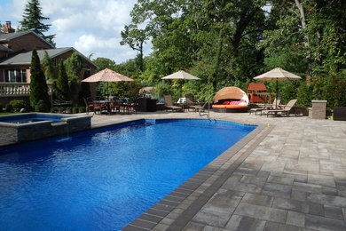Elegant backyard pool photo in New York