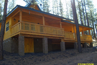 Example of a mid-sized mountain style two-story wood gable roof design in Phoenix